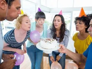 Group of coworkers celebrating an office birthday party