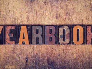 The word yearbook on a grungy wooden background