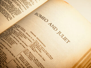 A book of William Shakespeare plays opened to the start of Romeo and Juliet