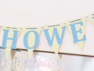 A decorative sign marking a baby shower